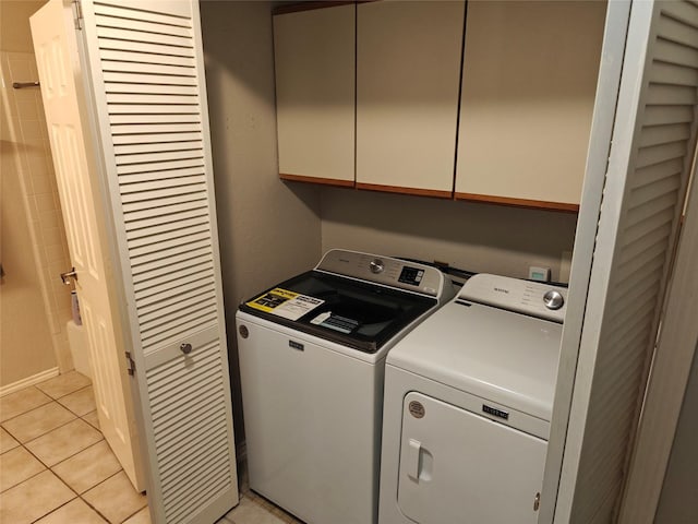 5309 San Mateo Ct, Arlington, TX 76017 - laundry area featuring washing machine and dryer, cabinet space, and light tile patterned floors