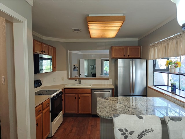 5309 San Mateo Ct, Arlington, TX 76017 - kitchen featuring stainless steel appliances, a sink, dark wood-style flooring, crown molding, and backsplash