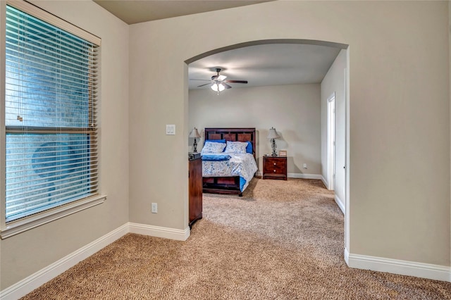6158 Stillhouse Ln, Fort Worth, TX 76179 - carpeted bedroom featuring arched walkways, multiple windows, baseboards, and a ceiling fan
