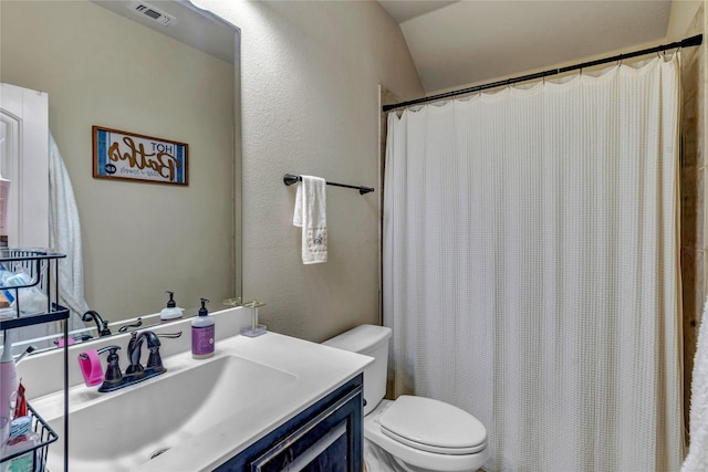 6158 Stillhouse Ln, Fort Worth, TX 76179 - bathroom with toilet, vanity, a textured wall, lofted ceiling, and a shower with shower curtain