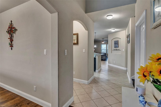 6158 Stillhouse Ln, Fort Worth, TX 76179 - corridor featuring arched walkways, baseboards, and light tile patterned floors