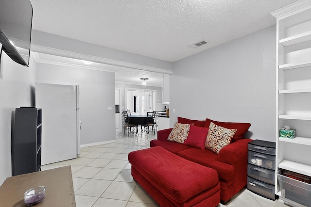 2913 Harlan Dr, Mesquite, TX 75150 - living area featuring a textured ceiling, light tile patterned floors, baseboards, and crown molding