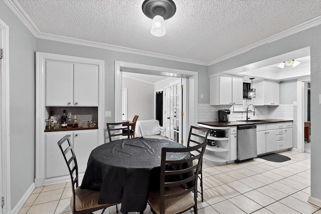 2913 Harlan Dr, Mesquite, TX 75150 - dining area featuring light tile patterned flooring, ornamental molding, and a textured ceiling