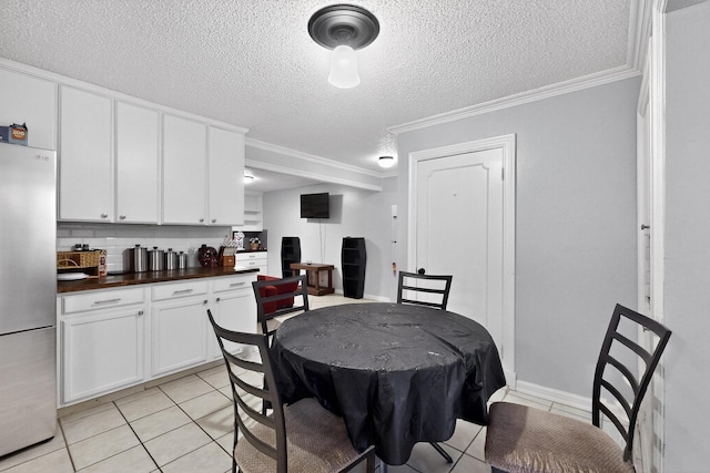 2913 Harlan Dr, Mesquite, TX 75150 - dining space featuring ornamental molding, a textured ceiling, and light tile patterned flooring