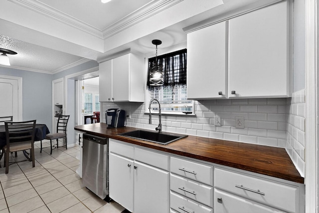 2913 Harlan Dr, Mesquite, TX 75150 - kitchen with stainless steel dishwasher, wooden counters, a sink, light tile patterned floors, and backsplash