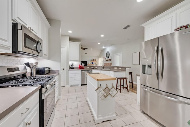 1301 Shell Beach Dr, Little Elm, TX 75068 - kitchen featuring stainless steel appliances, butcher block counters, a peninsula, a sink, and recessed lighting