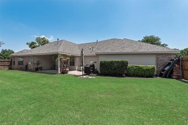 1301 Shell Beach Dr, Little Elm, TX 75068 - back of property featuring a patio, brick siding, and a shingled roof