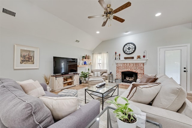 1301 Shell Beach Dr, Little Elm, TX 75068 - living room with wood finished floors, vaulted ceiling, ceiling fan, a fireplace, and recessed lighting