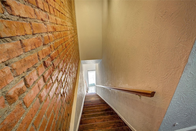 1213 Washington St Unit B, Commerce, TX 75428 - staircase with wood finished floors and a textured wall