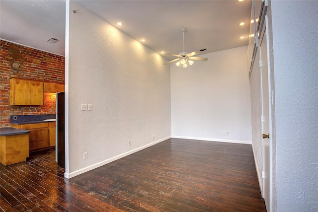 1213 Washington St Unit B, Commerce, TX 75428 - spare room featuring dark wood-style flooring, a ceiling fan, baseboards, a textured wall, and recessed lighting