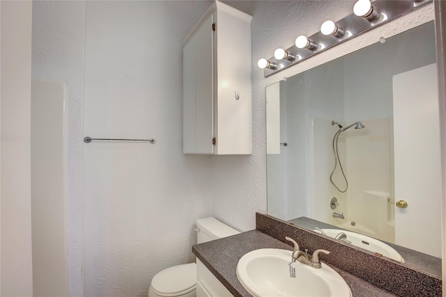 1213 Washington St Unit B, Commerce, TX 75428 - bathroom with a textured wall, toilet, and vanity