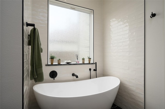 105 Shawnee Trl, Pottsboro, TX 75076 - full bath featuring a soaking tub, plenty of natural light, and tile walls