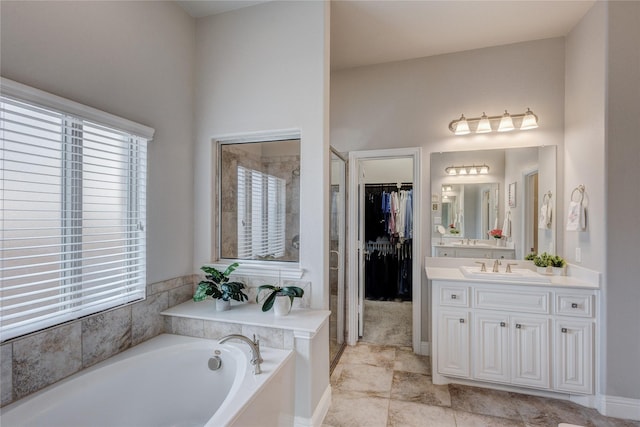 1211 Great Meadows Dr, Wylie, TX 75098 - full bathroom featuring a bath, vanity, healthy amount of natural light, and a walk in closet
