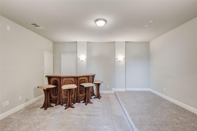 1211 Great Meadows Dr, Wylie, TX 75098 - dining space featuring a bar, light carpet, and baseboards