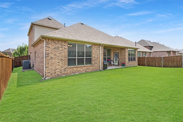 1211 Great Meadows Dr, Wylie, TX 75098 - back of property featuring central AC unit, brick siding, a patio, and a shingled roof