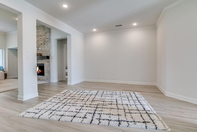 1721 Gem Dr, Rockwall, TX 75087 - spare room with wood finished floors, a fireplace, crown molding, baseboards, and recessed lighting
