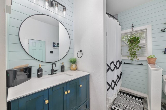 2832 Forest Ave, Fort Worth, TX 76112 - full bath featuring vanity, decorative backsplash, and wooden walls