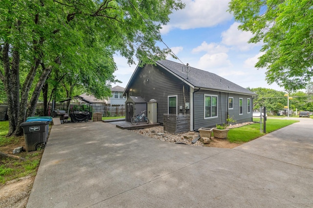 2832 Forest Ave, Fort Worth, TX 76112 - view of property exterior featuring a shed, driveway, and roof with shingles
