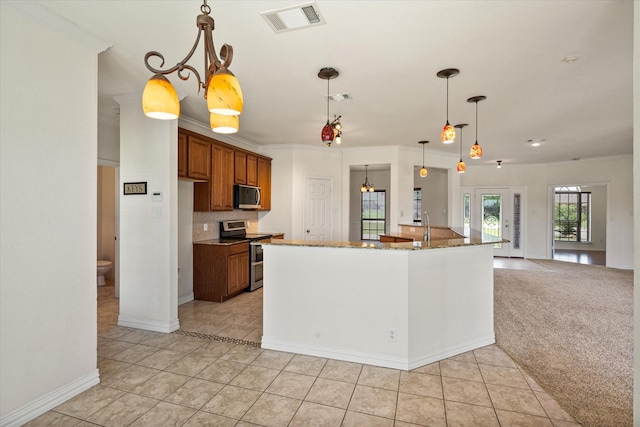 104 Spring Creek Dr, Waxahachie, TX 75165 - kitchen featuring stainless steel appliances, brown cabinetry, light tile patterned flooring, stone countertops, and pendant lighting