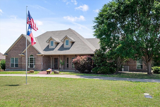 104 Spring Creek Dr, Waxahachie, TX 75165 - view of front of property featuring brick siding, a front yard, and roof with shingles