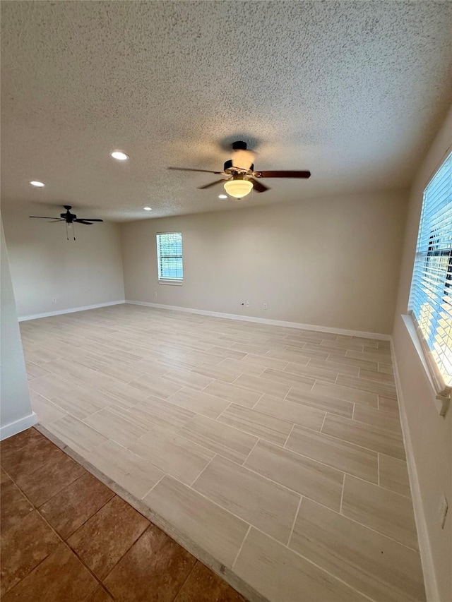 739 W Pine St, Jacksboro, TX 76458 - spare room with ceiling fan, recessed lighting, baseboards, and a textured ceiling