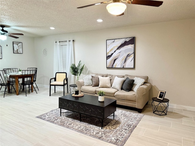 739 W Pine St, Jacksboro, TX 76458 - living room featuring a ceiling fan, a textured ceiling, baseboards, and recessed lighting
