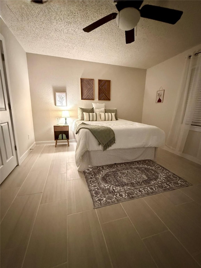 739 W Pine St, Jacksboro, TX 76458 - bedroom with wood finished floors, a textured ceiling, ceiling fan, and baseboards