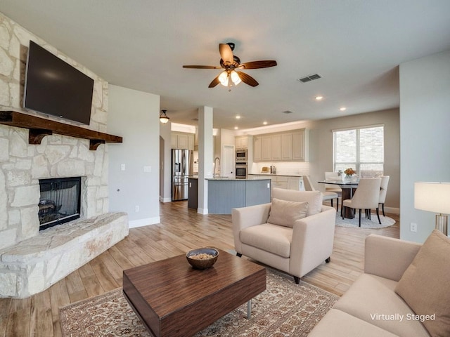 1517 Port Millstone Trl, Wylie, TX 75098 - living room featuring a ceiling fan, a fireplace, light wood finished floors, recessed lighting, and baseboards