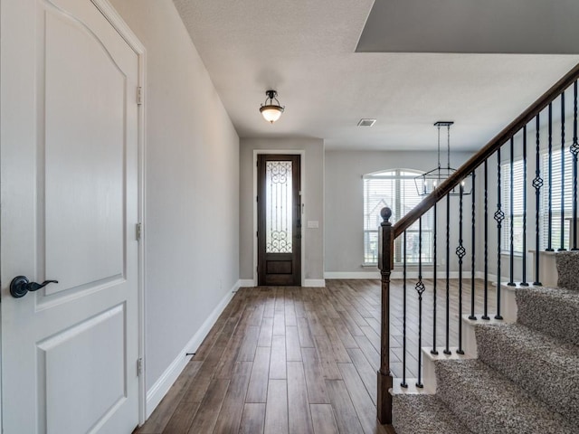 1517 Port Millstone Trl, Wylie, TX 75098 - entryway with stairway, baseboards, dark wood-style floors, and a chandelier