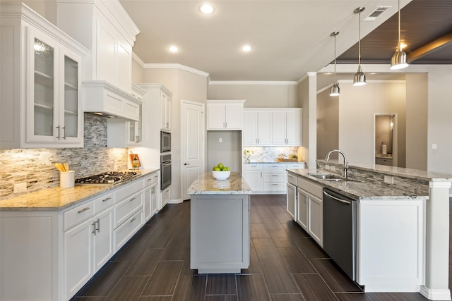 704 Prairie Timber Rd, Burleson, TX 76028 - kitchen featuring stainless steel appliances, a center island with sink, a sink, ornamental molding, and backsplash