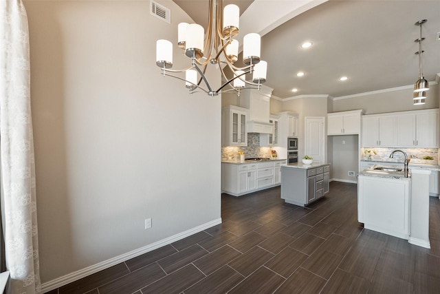 704 Prairie Timber Rd, Burleson, TX 76028 - kitchen with a center island with sink, decorative backsplash, appliances with stainless steel finishes, crown molding, and a sink