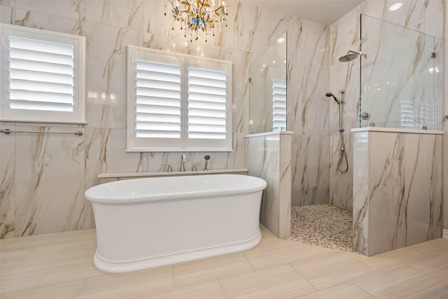704 Prairie Timber Rd, Burleson, TX 76028 - bathroom featuring a soaking tub, a marble finish shower, and a chandelier