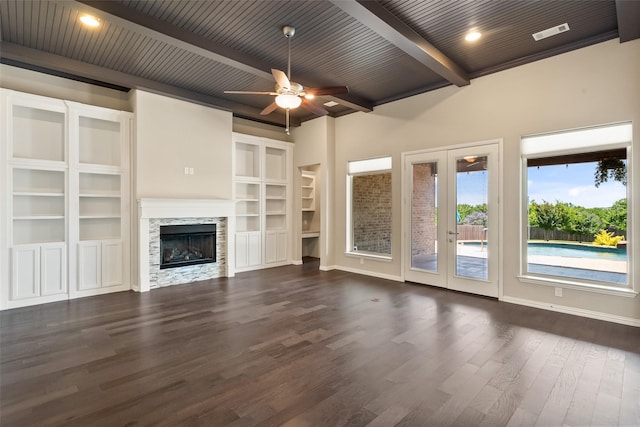 704 Prairie Timber Rd, Burleson, TX 76028 - unfurnished living room featuring french doors, dark wood-style flooring, ceiling fan, a fireplace, and wood ceiling with exposed beams