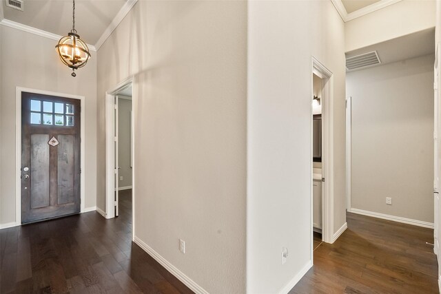 704 Prairie Timber Rd, Burleson, TX 76028 - foyer entrance with ornamental molding, dark wood-type flooring, a high ceiling, baseboards, and a chandelier