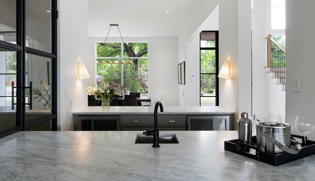 4207 Valley Ridge Rd, Dallas, TX 75220 - kitchen featuring beverage cooler, a sink, and light stone counters