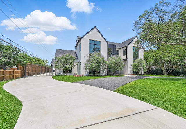 4207 Valley Ridge Rd, Dallas, TX 75220 - view of front facade with concrete driveway, stucco siding, and a gate