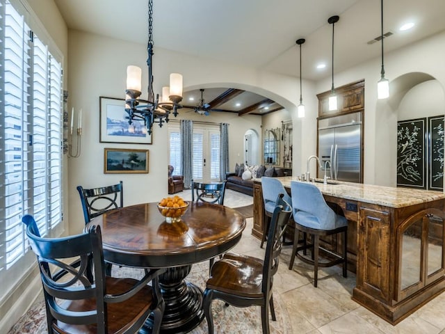656 Clearwater Dr, Irving, TX 75039 - dining space featuring arched walkways, a chandelier, plenty of natural light, recessed lighting, and light tile patterned floors