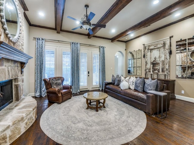 656 Clearwater Dr, Irving, TX 75039 - living area featuring arched walkways, a ceiling fan, baseboards, wood finished floors, and beam ceiling
