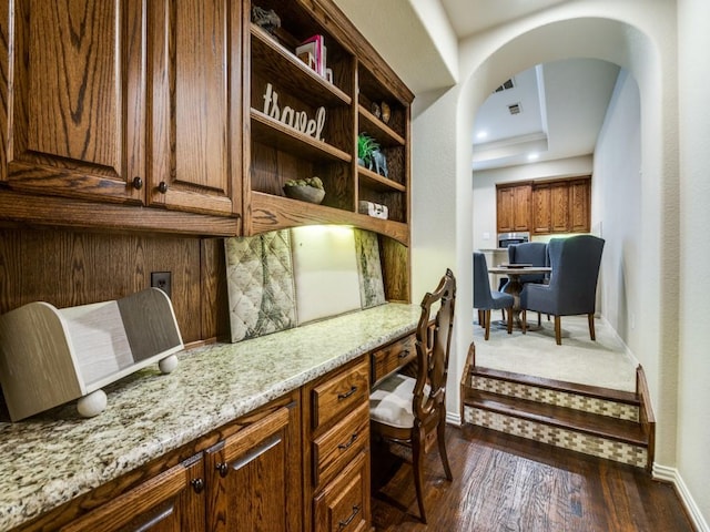 656 Clearwater Dr, Irving, TX 75039 - home office with baseboards, dark wood finished floors, and arched walkways