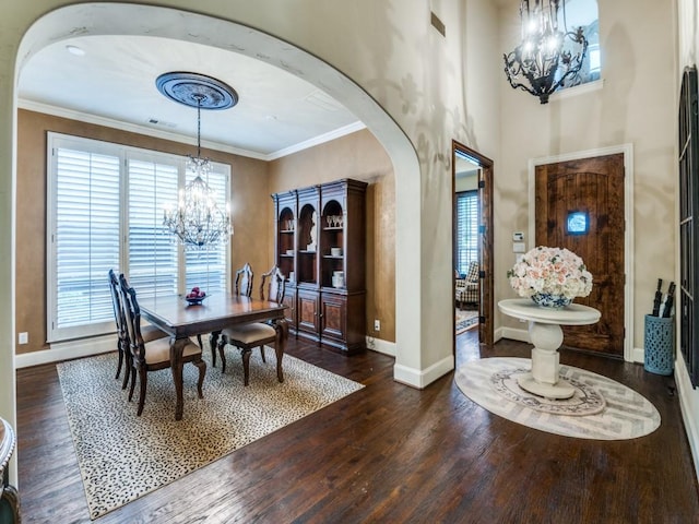 656 Clearwater Dr, Irving, TX 75039 - dining room with a chandelier, arched walkways, dark wood-style flooring, ornamental molding, and baseboards