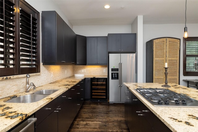 2411 N Hall St Unit 40, Dallas, TX 75204 - kitchen with stainless steel appliances, a sink, dark wood finished floors, wine cooler, and decorative backsplash