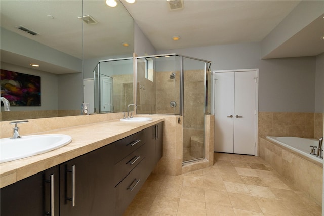 2411 N Hall St Unit 40, Dallas, TX 75204 - full bathroom with double vanity, a stall shower, a garden tub, tile patterned flooring, and recessed lighting