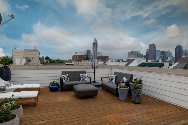2411 N Hall St Unit 40, Dallas, TX 75204 - wooden terrace featuring a view of skyline and an outdoor living space
