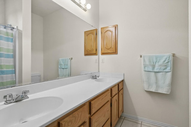 3304 Brooke St, Denton, TX 76207 - bathroom with tile patterned flooring, double vanity, toilet, and baseboards