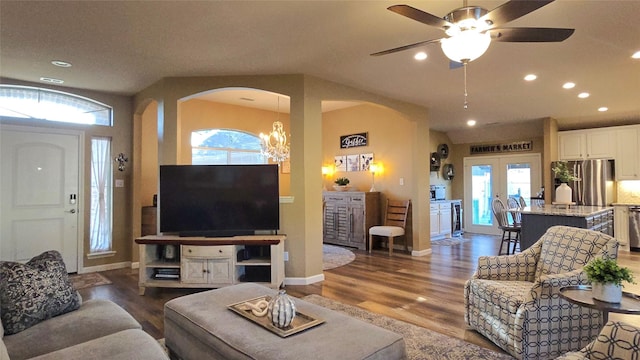 504 Greenwood Ln, Krum, TX 76249 - living area with arched walkways, wood finished floors, recessed lighting, baseboards, and healthy amount of natural light