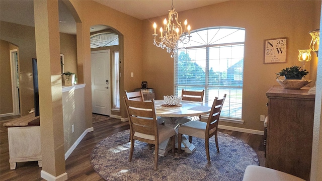 504 Greenwood Ln, Krum, TX 76249 - dining area with arched walkways, dark wood-style floors, a chandelier, and baseboards