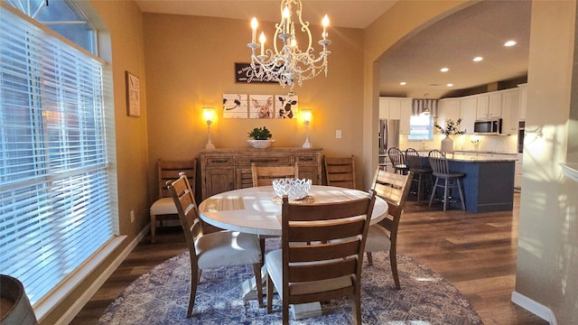 504 Greenwood Ln, Krum, TX 76249 - dining room featuring dark wood finished floors, arched walkways, a chandelier, recessed lighting, and baseboards