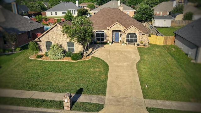 504 Greenwood Ln, Krum, TX 76249 - french country home featuring brick siding, roof with shingles, driveway, and a residential view