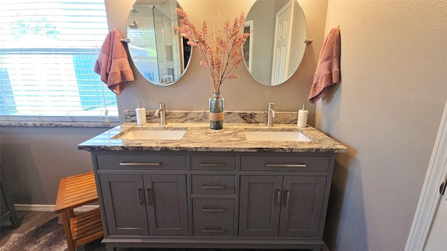 504 Greenwood Ln, Krum, TX 76249 - bathroom featuring double vanity and baseboards