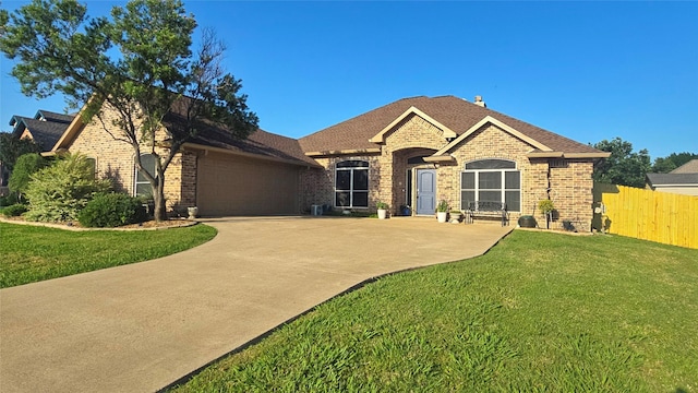 504 Greenwood Ln, Krum, TX 76249 - view of front facade featuring brick siding, a garage, concrete driveway, and a shingled roof